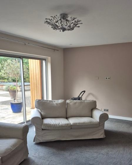 Living room patio-door wall after painting in a warm neutral colour